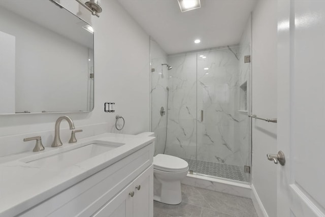 bathroom with tile patterned floors, vanity, toilet, and a shower with shower door