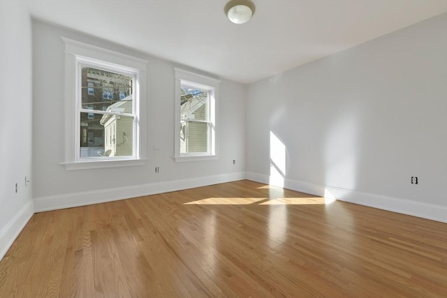 unfurnished room with light wood-type flooring