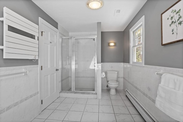 full bathroom with toilet, tile walls, baseboard heating, a wainscoted wall, and a shower stall