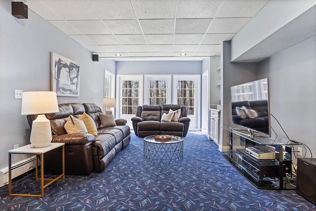 living room featuring carpet flooring, a baseboard heating unit, and a drop ceiling