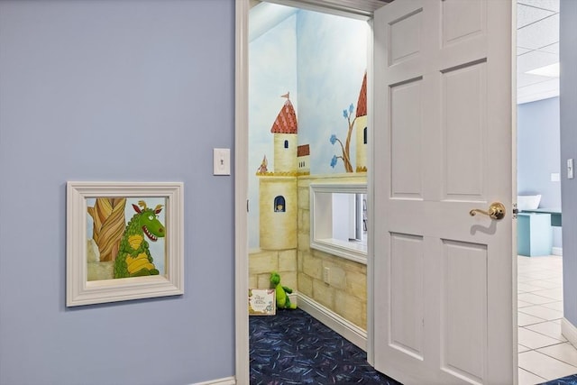 hall with tile patterned floors