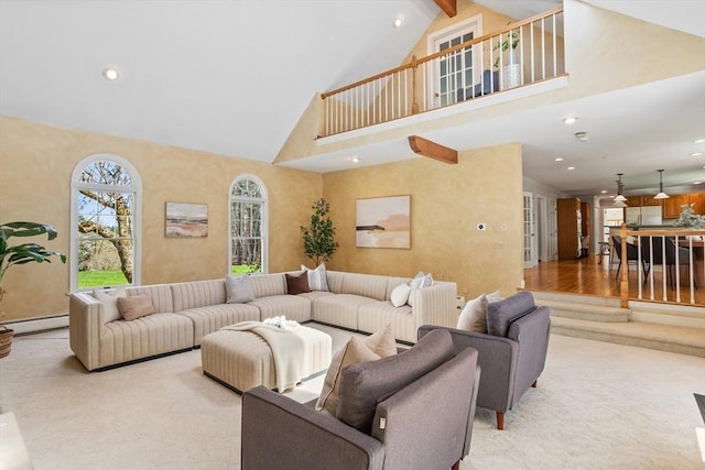 living room with beam ceiling, high vaulted ceiling, light colored carpet, recessed lighting, and a baseboard heating unit