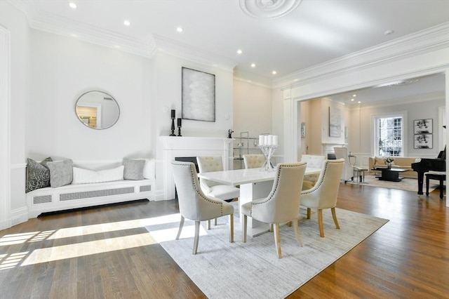 dining space with recessed lighting, wood finished floors, and crown molding
