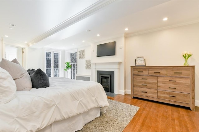 bedroom with recessed lighting, light wood-type flooring, and crown molding