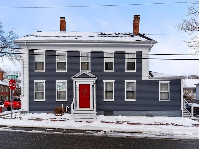 neoclassical / greek revival house with a chimney