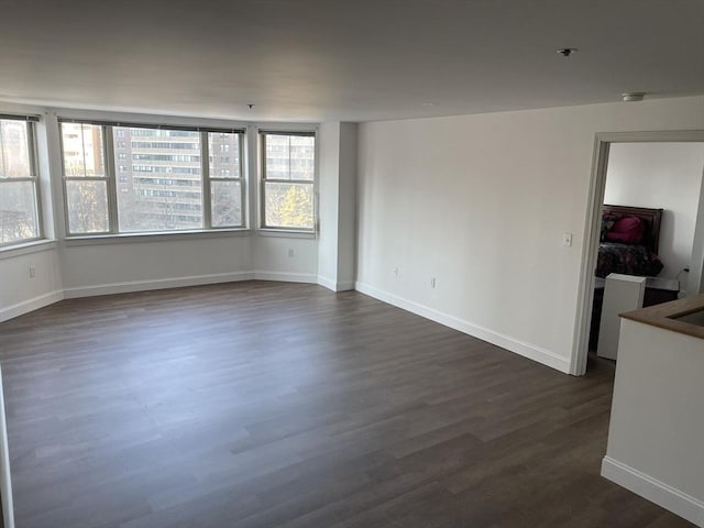 spare room with dark wood-type flooring