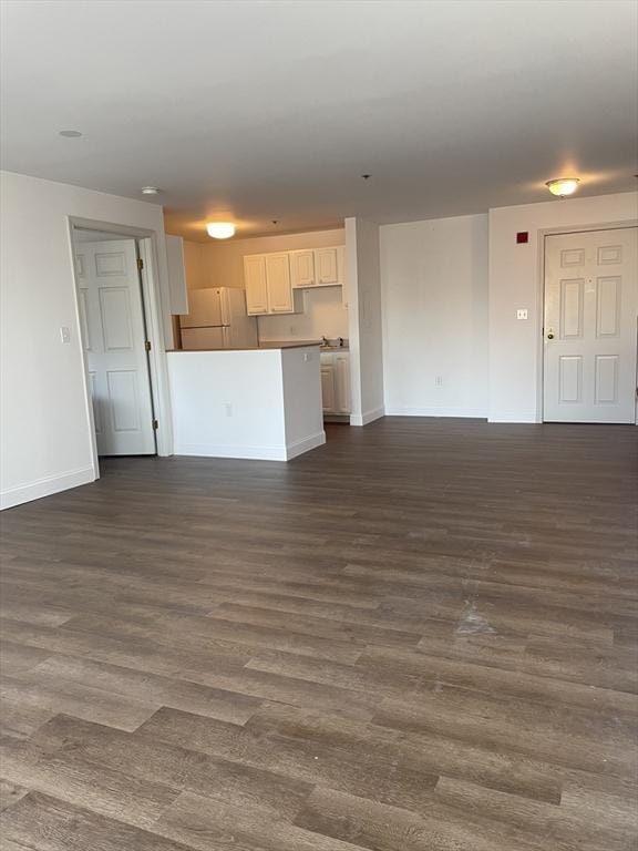 unfurnished living room with dark hardwood / wood-style flooring