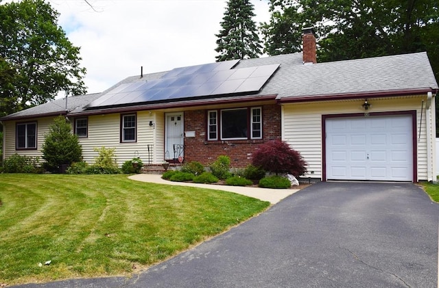 22 Verndale Rd, Weymouth, MA 02190 - ranch-style house featuring a garage, a front lawn, a chimney, driveway, and roof mounted solar panels