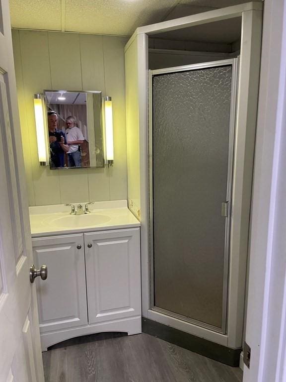 26 Wwebster Rd, Manchester, NH 03104 - bathroom featuring wood finished floors, vanity, and a shower stall