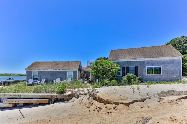 view of front of home featuring roof with shingles