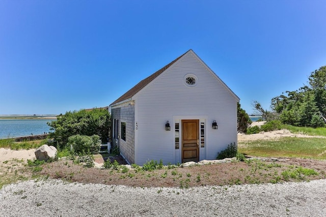 view of front of house with a water view