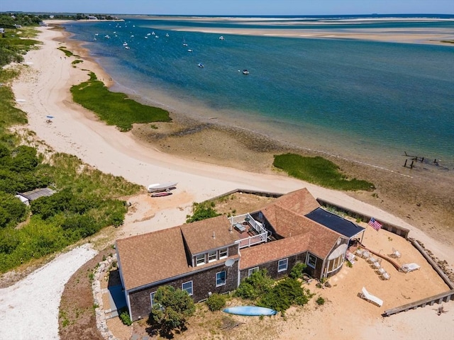 drone / aerial view featuring a view of the beach and a water view