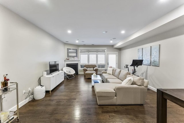 living area with a fireplace, recessed lighting, baseboards, and dark wood finished floors