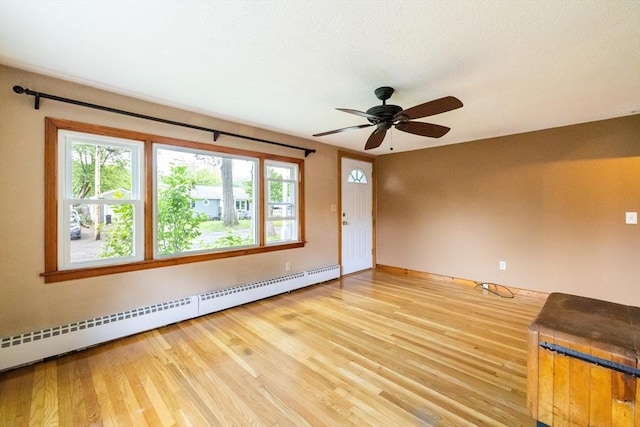 41 Yvette St, Chicopee, MA 01020 - unfurnished room with baseboard heating, healthy amount of natural light, wood finished floors, and ceiling fan