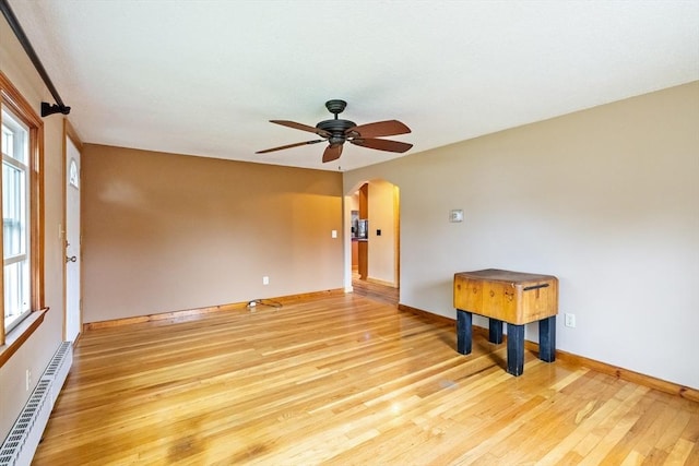 41 Yvette St, Chicopee, MA 01020 - empty room with arched walkways, ceiling fan, light wood-style floors, and healthy amount of natural light
