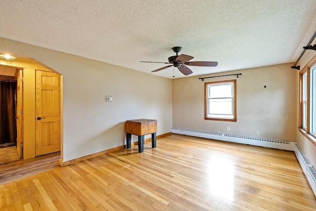 41 Yvette St, Chicopee, MA 01020 - spare room featuring a baseboard heating unit, a textured ceiling, light wood-style flooring, and a ceiling fan