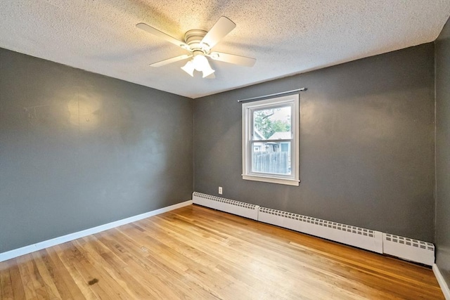 41 Yvette St, Chicopee, MA 01020 - empty room with a baseboard heating unit, ceiling fan, wood finished floors, and a textured ceiling