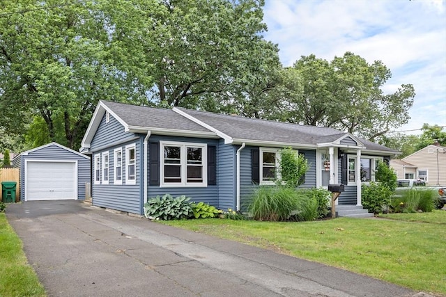 41 Yvette St, Chicopee, MA 01020 - view of front of home featuring an outbuilding, a garage, a front lawn, driveway, and a shingled roof