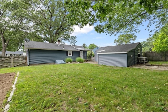 41 Yvette St, Chicopee, MA 01020 - rear view of house with a fenced backyard and an outdoor structure