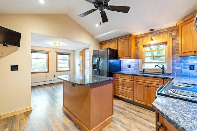 41 Yvette St, Chicopee, MA 01020 - kitchen with black fridge with ice dispenser, a baseboard radiator, brown cabinets, a center island, and vaulted ceiling