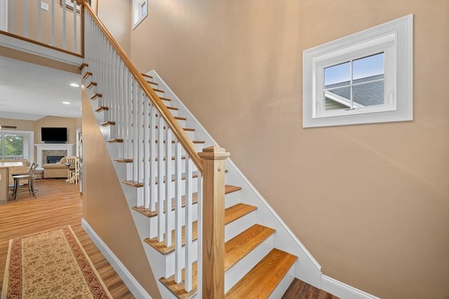 11 Soucy Dr Unit 11, Rutland, MA 01543 - stairway featuring wood finished floors, a fireplace, and a high ceiling