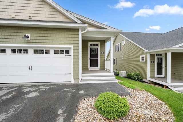 11 Soucy Dr Unit 11, Rutland, MA 01543 - property entrance featuring an attached garage and asphalt driveway