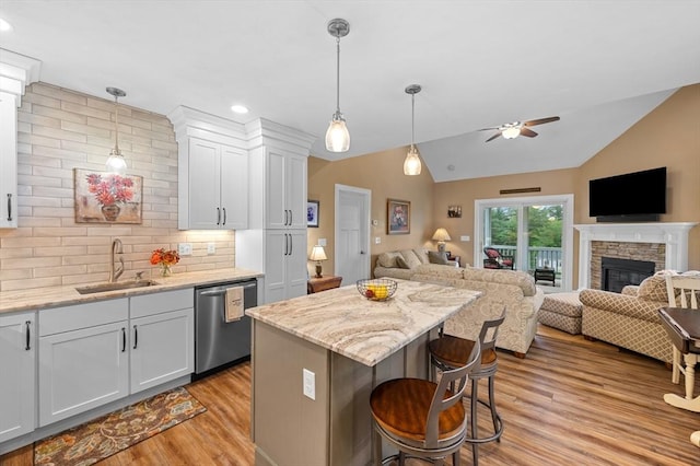 11 Soucy Dr Unit 11, Rutland, MA 01543 - kitchen featuring dishwasher, open floor plan, light wood finished floors, a ceiling fan, and a stone fireplace