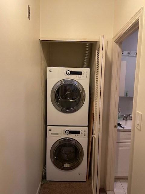 58 S St Unit 306, Quincy, MA 02169 - laundry room featuring stacked washing machine and dryer