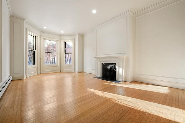 unfurnished living room featuring crown molding, light hardwood / wood-style flooring, and a premium fireplace