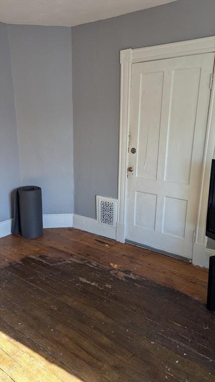 unfurnished room featuring dark hardwood / wood-style flooring