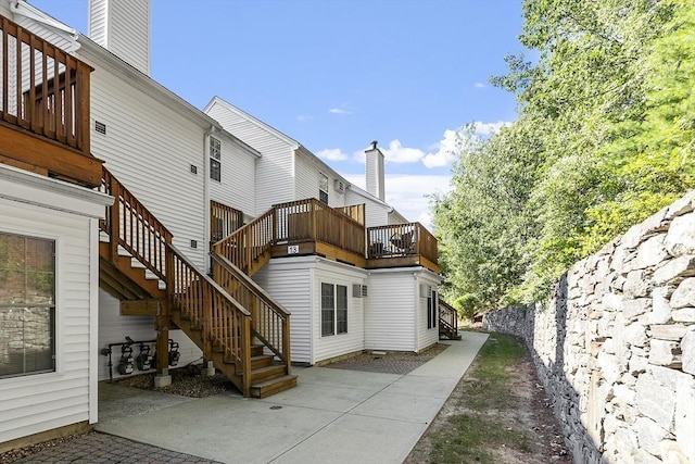 13 Berrington Rd Unit 13, Leominster, MA 01453 - rear view of property featuring a patio area, stairs, and a chimney