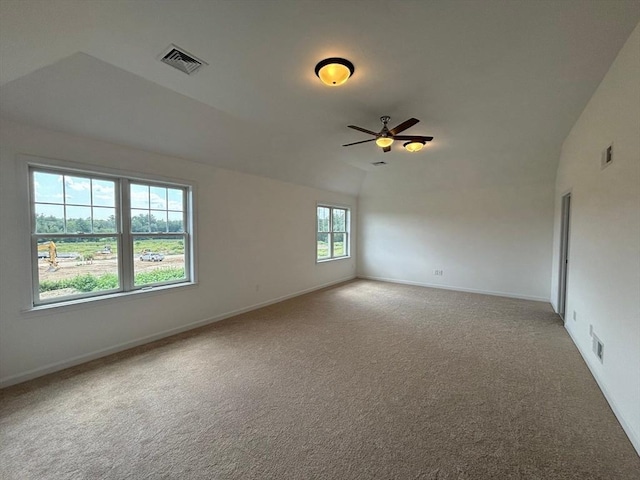 empty room with carpet, ceiling fan, and vaulted ceiling