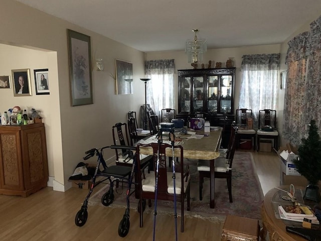 dining area featuring an inviting chandelier and hardwood / wood-style flooring