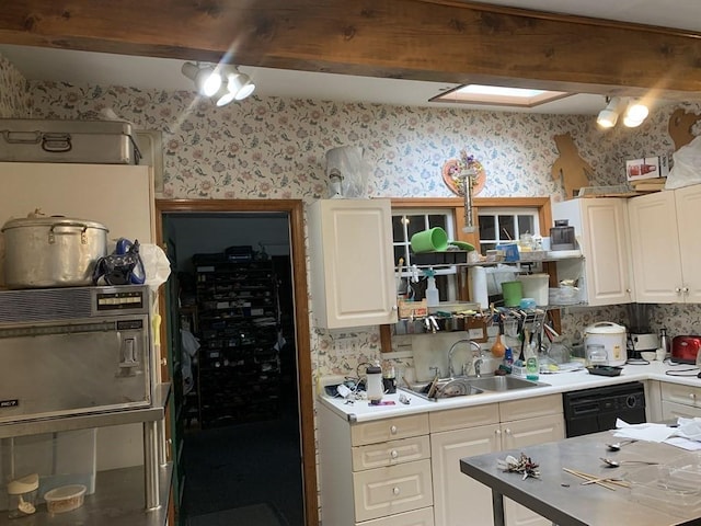 kitchen featuring dishwasher, white cabinetry, and sink