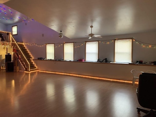 interior space with hardwood / wood-style floors, ceiling fan, and vaulted ceiling