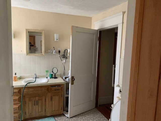 bathroom featuring tile patterned floors, decorative backsplash, tile walls, and vanity