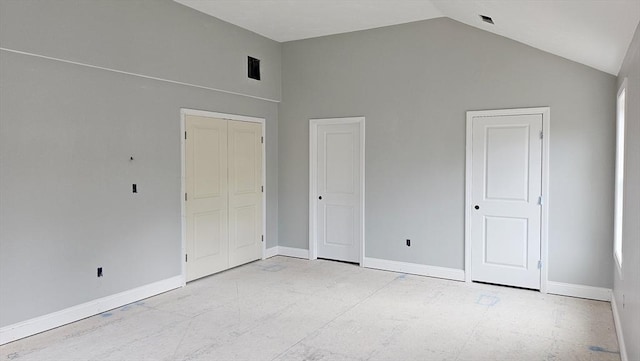 unfurnished bedroom with high vaulted ceiling and baseboards