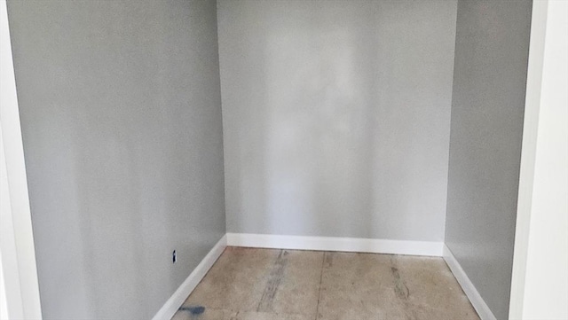 unfurnished room featuring baseboards