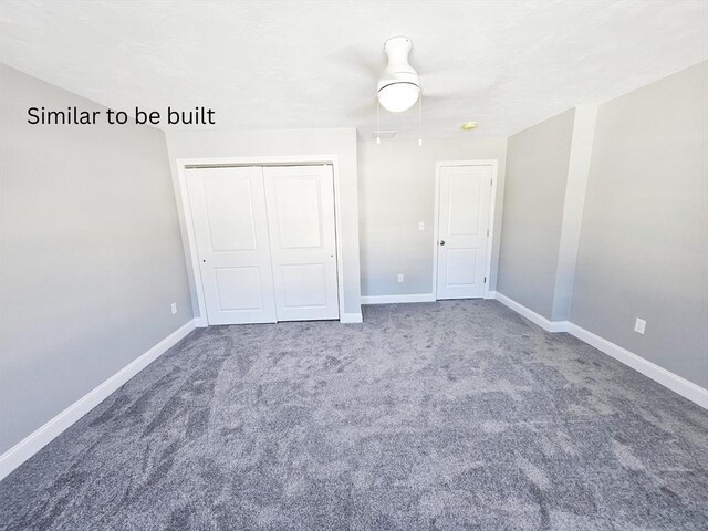 unfurnished bedroom featuring carpet, baseboards, and a closet