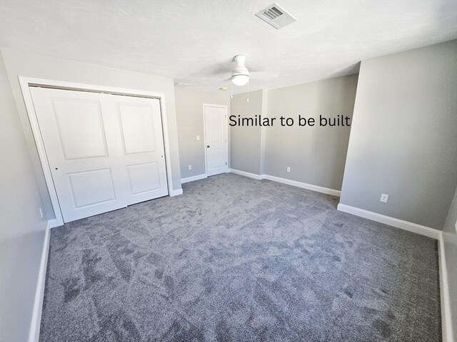 unfurnished bedroom with visible vents, baseboards, dark colored carpet, and a closet