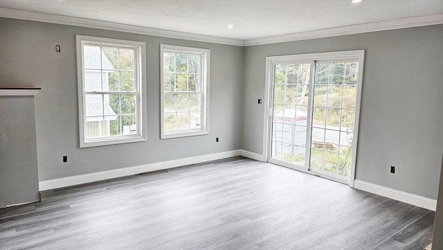 interior space featuring crown molding, plenty of natural light, and baseboards