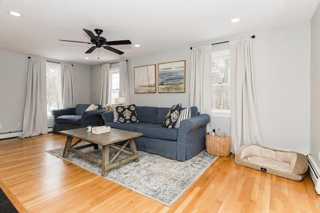 living room featuring ceiling fan and hardwood / wood-style floors