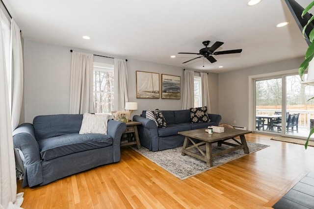 living room with ceiling fan and wood-type flooring