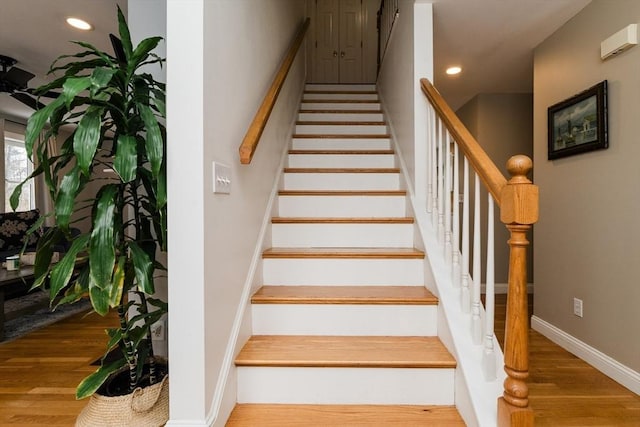 stairway featuring hardwood / wood-style flooring