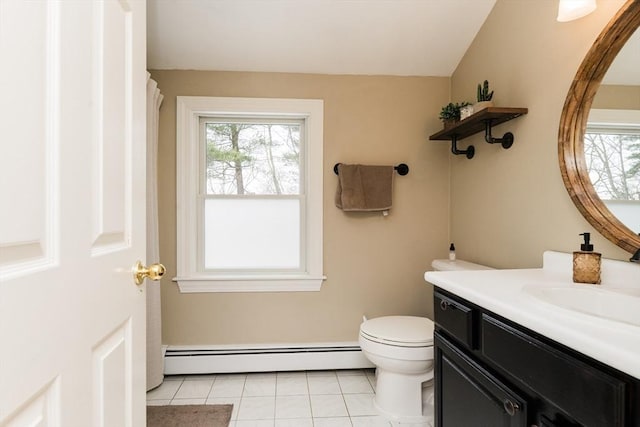 bathroom featuring baseboard heating, vanity, tile patterned floors, and plenty of natural light