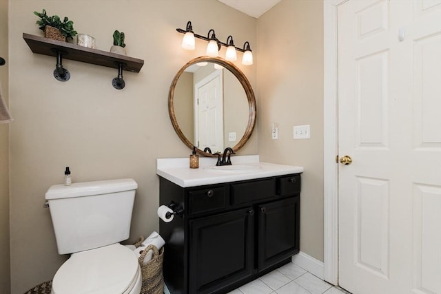 bathroom featuring vanity, tile patterned floors, and toilet