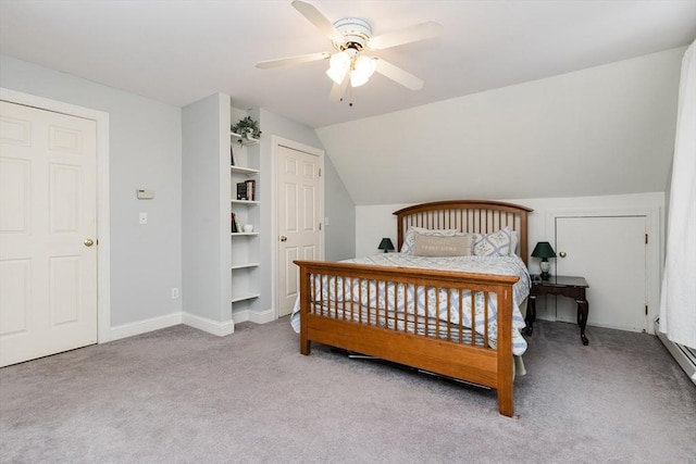 bedroom with ceiling fan, light colored carpet, and vaulted ceiling