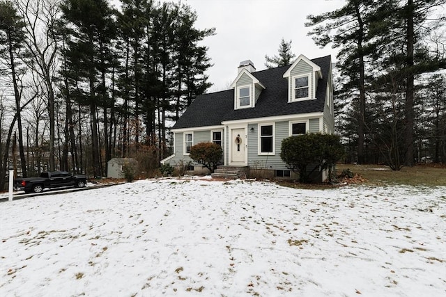 new england style home featuring a storage unit