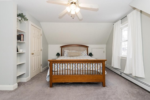 carpeted bedroom featuring lofted ceiling, a baseboard heating unit, and ceiling fan