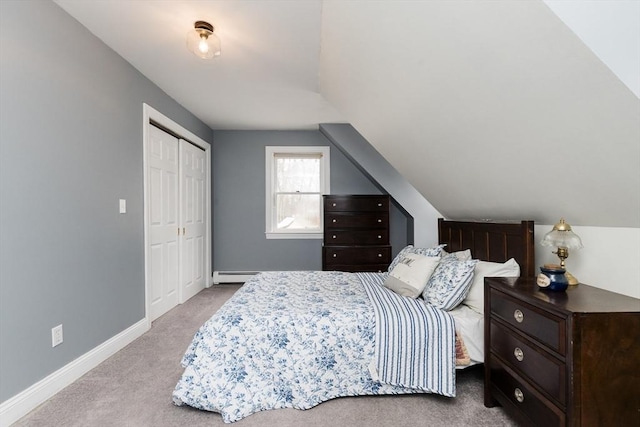 bedroom with lofted ceiling, a closet, a baseboard radiator, and light carpet